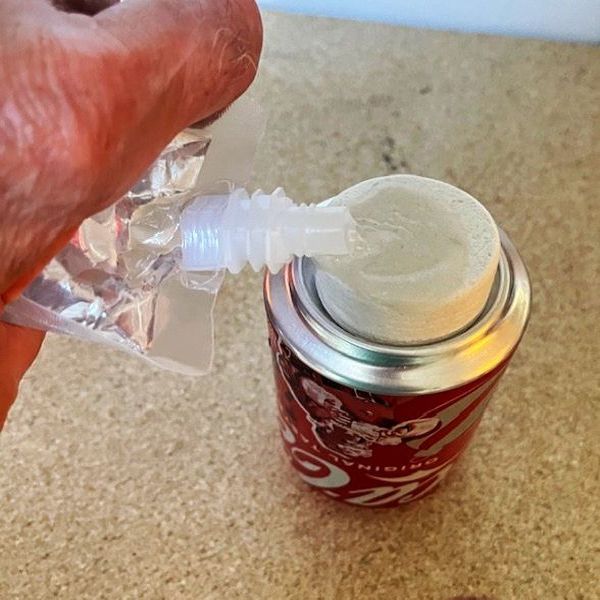 Pouring alcohol from a flask onto a white SnowStone